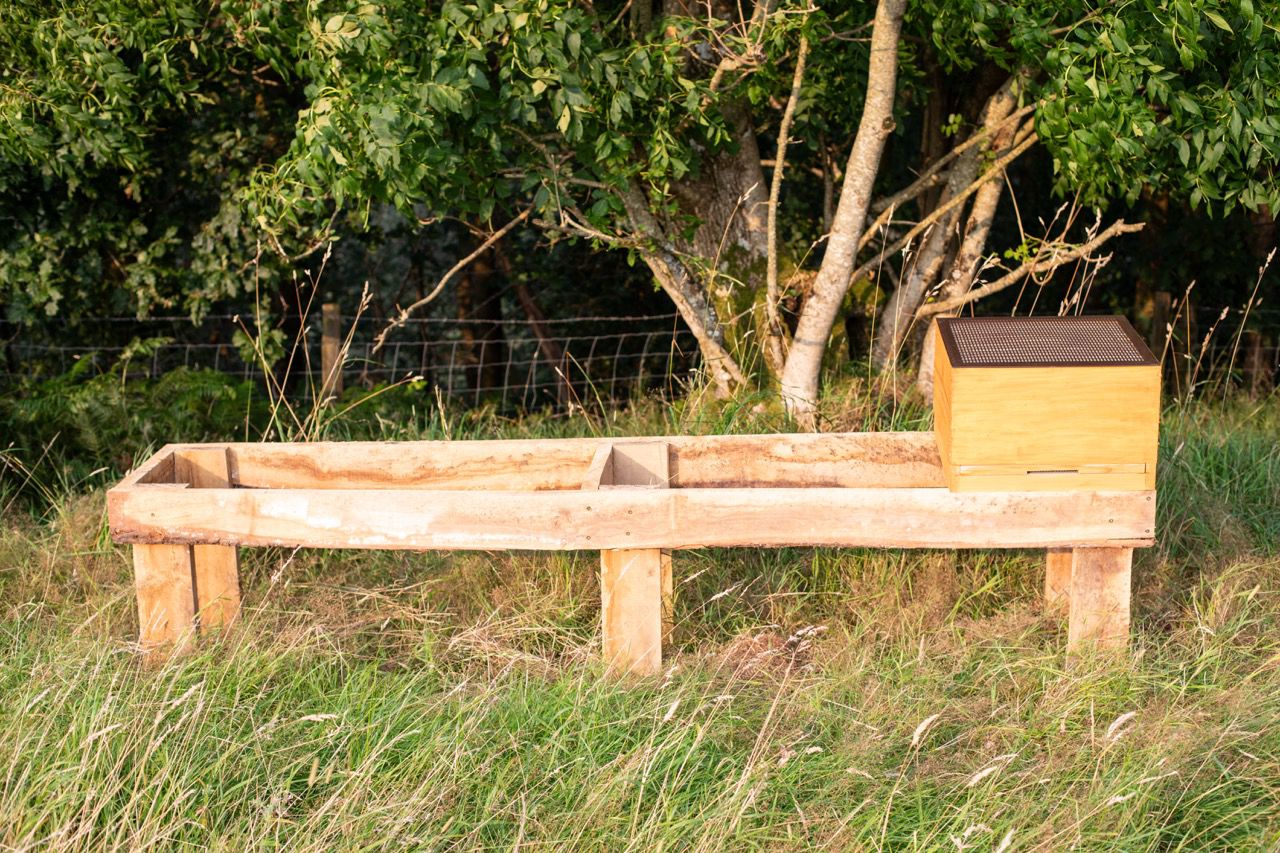 Bespoke timber apiary stand bench set in the countryside meadows of Carmarthenshire Dyfed