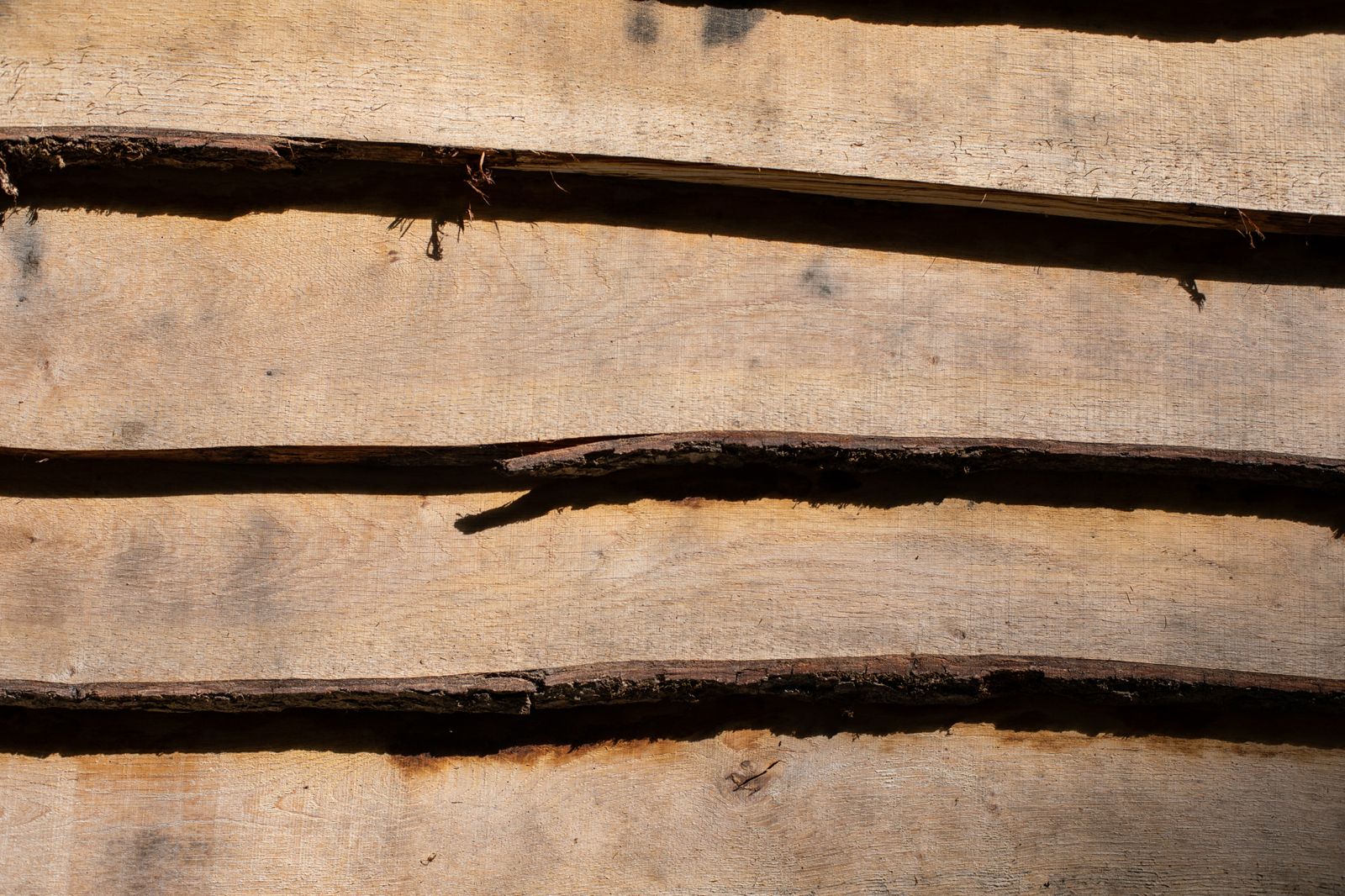 Close-up detail of handcrafted waney edge timber exterior cladding
